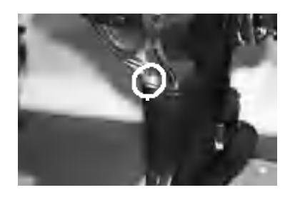 Loosening oil drain screw with container underneath
