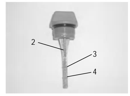 Dipstick showing upper and lower oil level marks